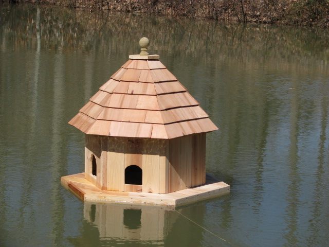Floating Duck house tethered on pully & cable system for easy access from bank.  Tiedown stakes, 250' of plastic coated cable & all stainless steel hardware.-- Tether system only $175-Complete. See explaination below